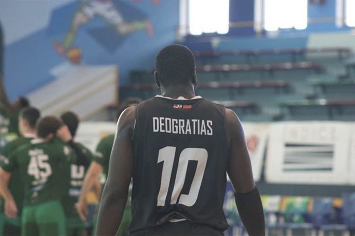 Anthony Deogratias, shirt #10, playing basketball. His basketball jersey is dark blue with white numbering and lettering.
