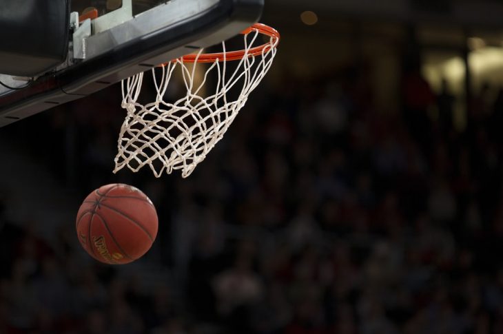 A basketball flying through the net.
