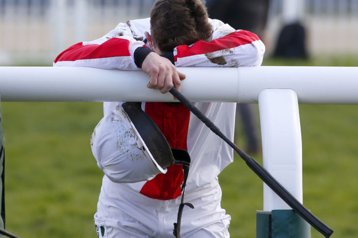 An inconsolable Jamie Moore after falling off Goshen in the Triumph Hurdle at the Cheltenham Festival this March (Source: racingtv.com)