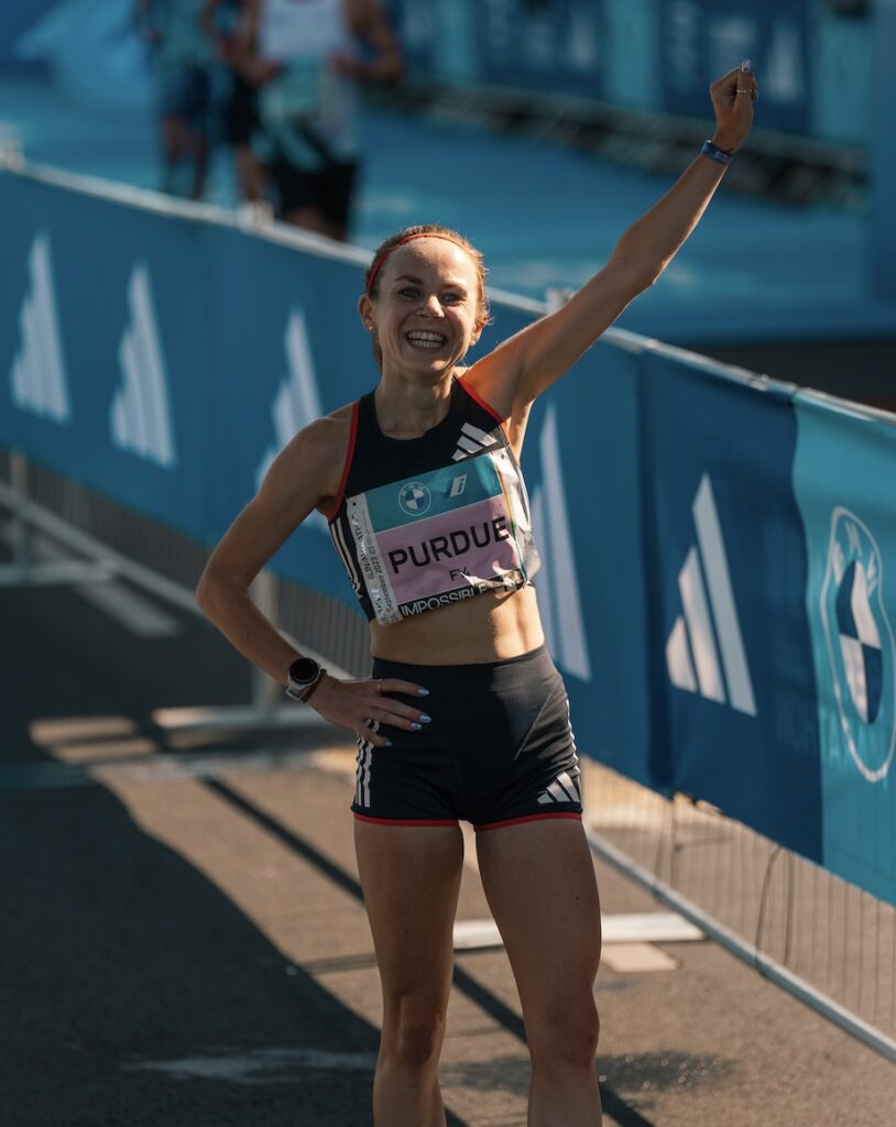 Charlotte Purdue waving to fans after finishing the Berlin Marathon