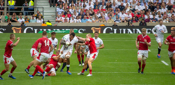 Welsh players attempt to tackle Courtney Lawes