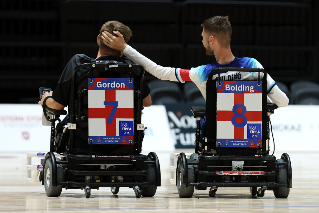 SYDNEY, AUSTRALIA - OCTOBER 17: Christopher Gordon and Jonathan Bolding of England celebrate a goal during the day 3 match between England and Australia of the 2023 FIPFA Powerchair World Cup at Quay Centre on October 17, 2023 in Sydney, Australia. 