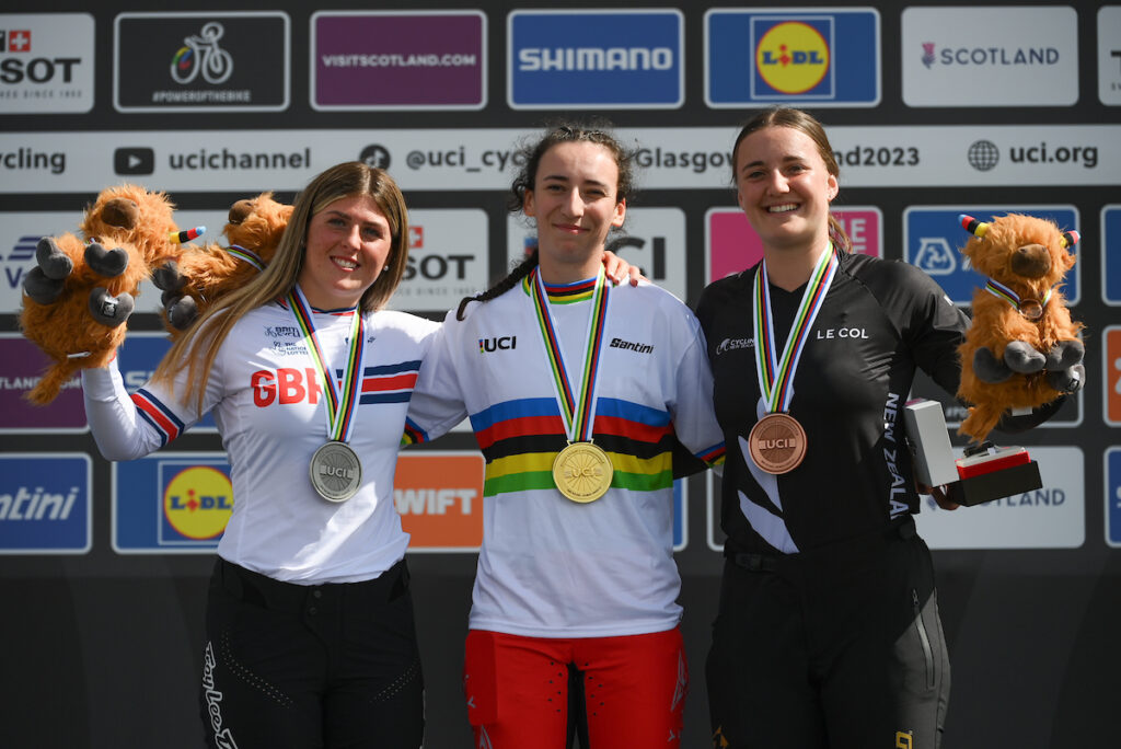 Emily Hutt wearing silver medal alongside gold and bronze medallists on the UCI Cycling World Championships podium