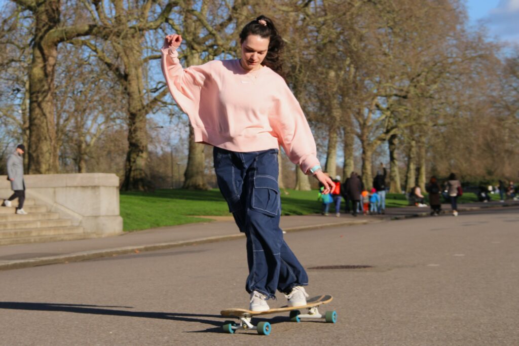 Chloé Kourga dancing on her longboard in Hyde Park