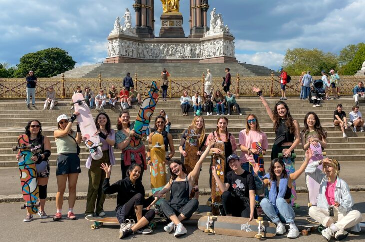 London Longboard Girls sit in front of the Royal Albert Memorial posing for a photo