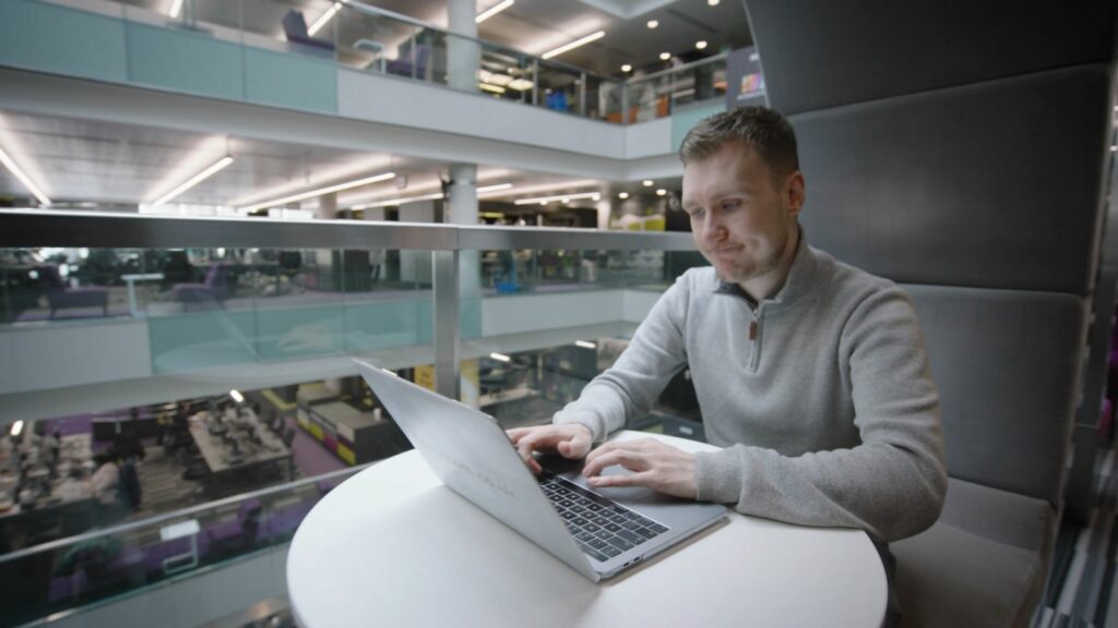 Nick Ransom sits working at a laptop in a BBC bulding.