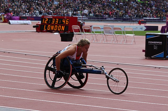 Hannah Cockroft competes in her racing wheelchair on the red track of the London Olympic Stadium. She has spoken about how the Government is failing disabled people.