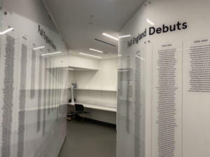 Honours boards listing each capped England men's and women's England international rugby players sit opposite each other inside the England dressing room