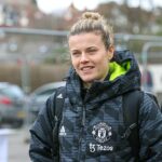 Hayley Ladd smiles in grey Manchester United coat. She will compete in the FA Cup Final on the 12th May 2024.