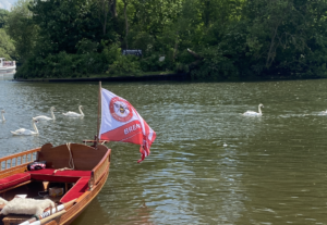 The Brentford flag attached to the rear of the boat flies in the wind