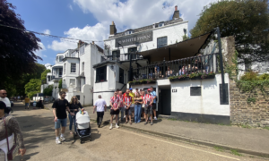 The crew stands outside the White Swan pub